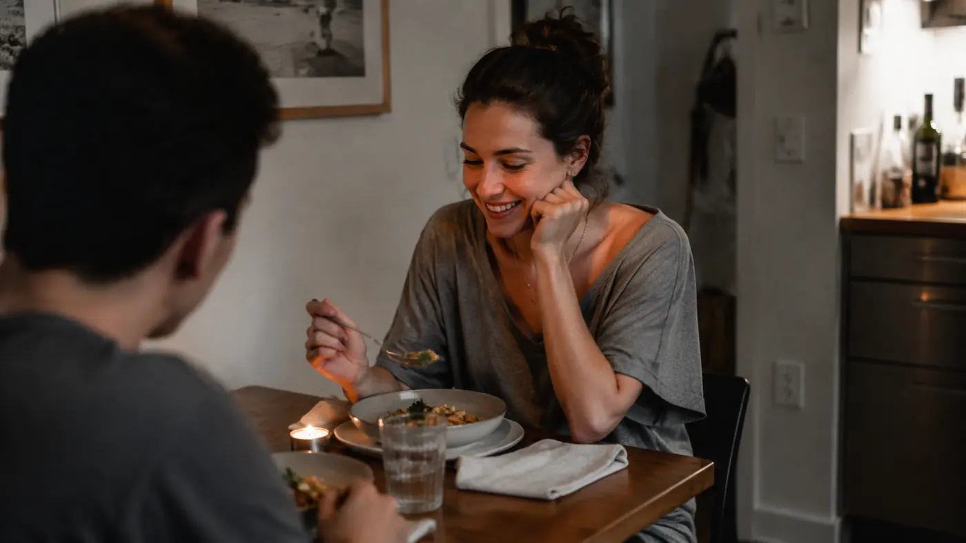 Bethany and Danny sitting at a small kitchen table sharing a simple air-fried dinner